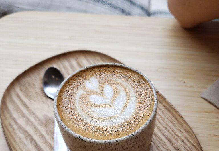 Taza de cortado servida en la barra de una cafetería de Sitges por la mañana