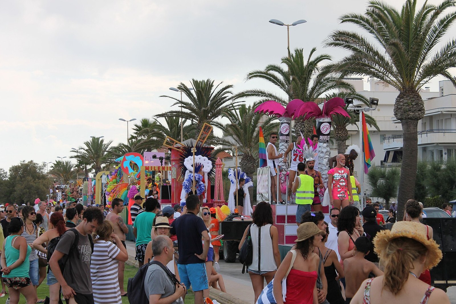 Ambiente del Gay Pride de Sitges, banderas arcoíris y público de fiesta en el paseo marítimo