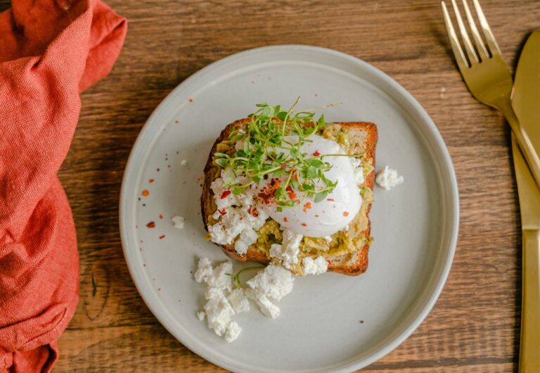 Sunlit Mediterranean brunch table in Sitges with eggs, toast and coffee
