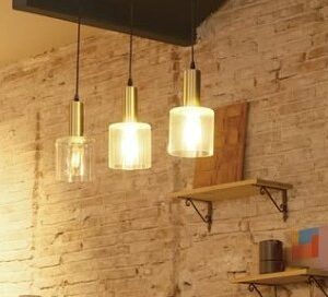 Inside The EMPWR coworking cafe in Sitges, exposed brick wall and warm pendant lights