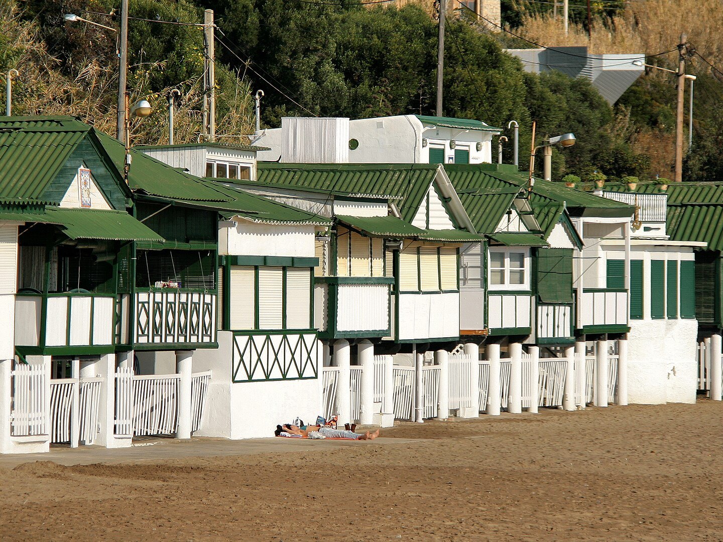 Green-and-white casetes, the historic bathing huts of Garraf beach near Sitges
